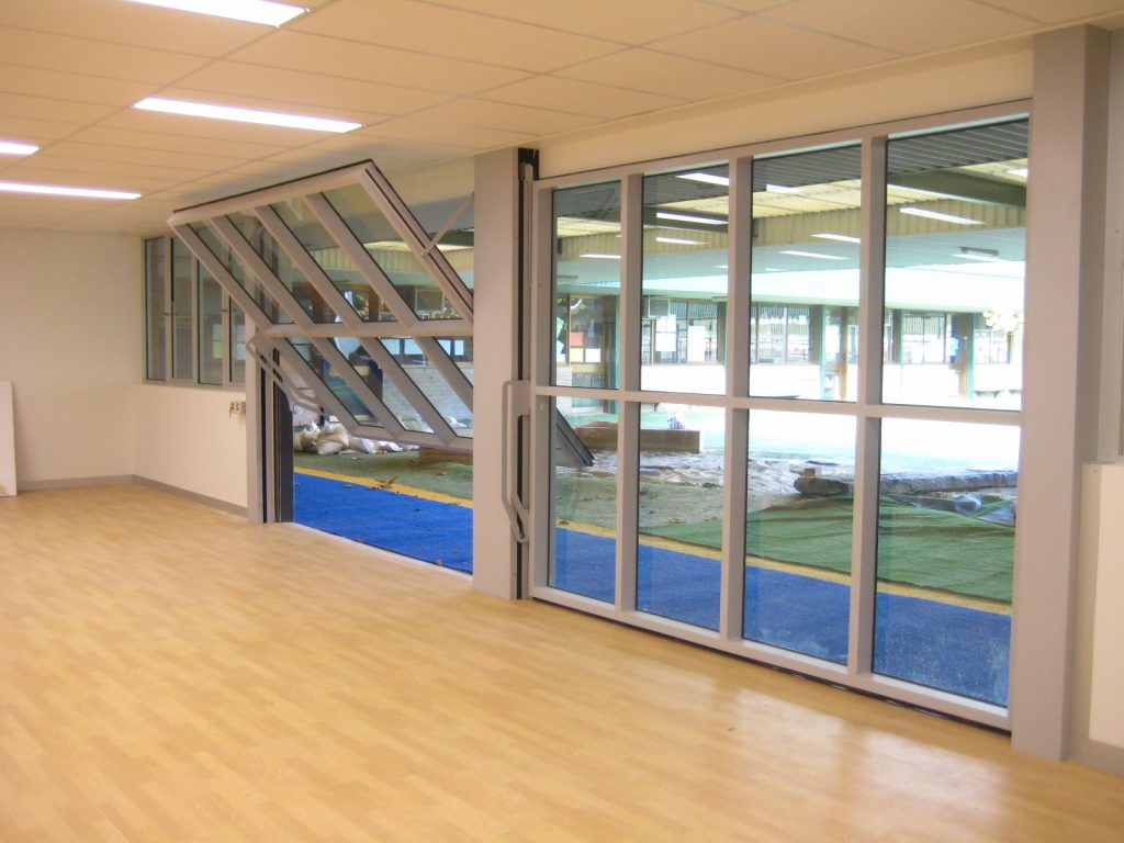 tilt glazed wall opening onto a play area and sand pit