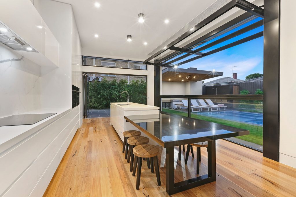 Family kitchen and meals area, open tilt window as dusk settles on the land.