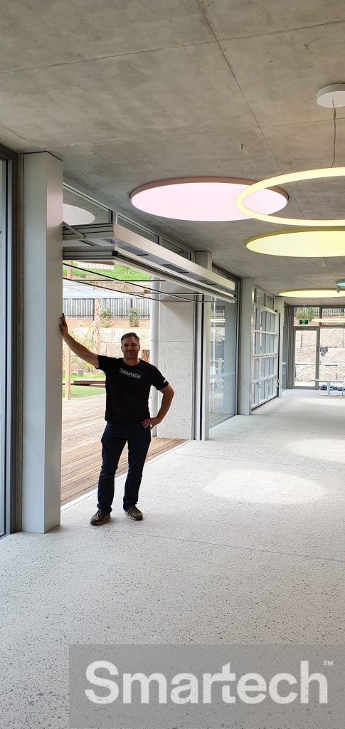 Anthony Cassar, standing beneath a newly installed glazed folding door at the good start early learning centre