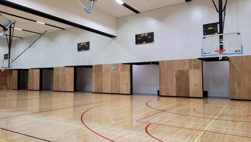 another angle of a school gym with open tilt doors