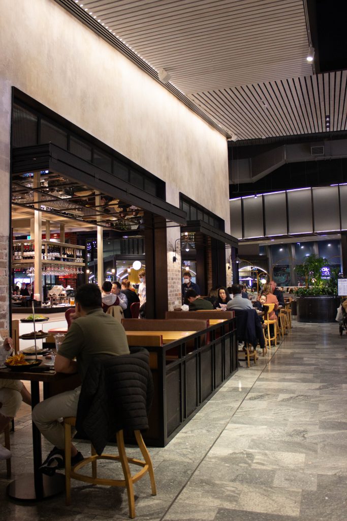 glazed folding doors opened above patrons enjoying dinner