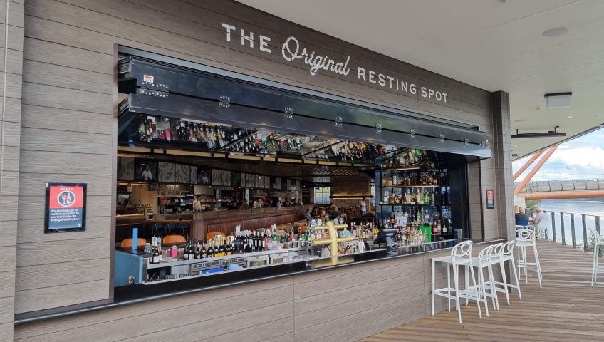 glazed folding window open above a well stocked bar