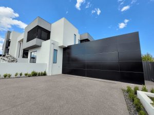 This image showcases a Façade Garage Door designed with Alucobond composite paneling, providing both style and durability.