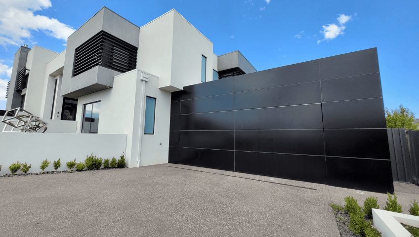 This image showcases a Façade Garage Door designed with Alucobond composite paneling, providing both style and durability.