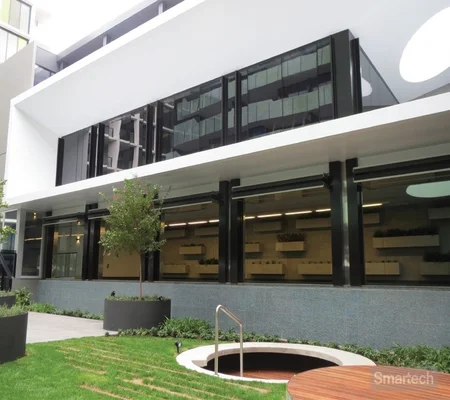 bask-in-the-fresh-air-as-you-lounge-in-the-pool-room-at-greensquare-apartments,-boasting-airy-glazed-folding-doors-open-wide.