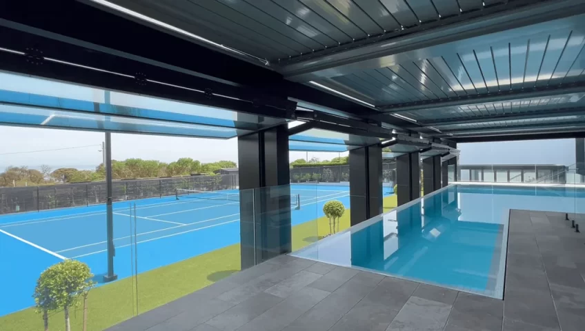 5 folding windows open, viewing the tennis courts and beautiful scene from the infinity pool